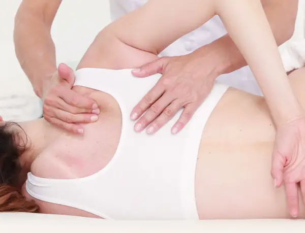 Woman Receiving Back Massage for Pain Relief Woman Receiving Back Massage from Massage Therapist